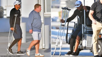 Tiger Woods seen on crutches as he arrives in Los Angeles, presumably for first time since horrific crash