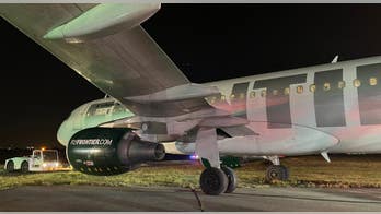 Frontier Airlines plane overshoots runway at Reagan airport near D.C., comes to a stop in the grass