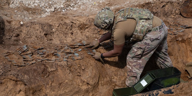 U.S. Air Force Staff Sgt. Foster Harvey, an explosive ordnance disposal technician with the 48th Civil Engineering Squadron, recovers .50 caliber rounds from a construction site at Royal Air Force Lakenheath, England, April 18th, 2021. After years underground, a total of 370 rounds were unearthed resulting in the largest amount of unexploded ordnance recovered from RAF Lakenheath on record by the EOD team. (U.S. Air Force photo by Airman Jacob Wood)