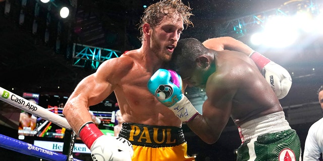 Logan Paul, left and Floyd Mayweather fight during an exhibition boxing match at Hard Rock Stadium, Sunday, June 6, 2021, in Miami Gardens, Fla.