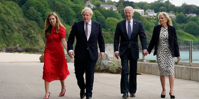 President Joe Biden and first lady Jill Biden are greeted and walk with British Prime Minister Boris Johnson and his wife Carrie Johnson, ahead of the G-7 summit, Thursday, June 10, 2021, in Carbis Bay, England. (AP Photo/Patrick Semansky)