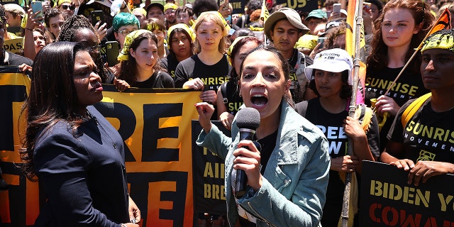 WASHINGTON, DC - JUNE 28: Rep. Cori Bush (D-MO) (L) and Rep. Alexandria Ocasio-Cortez (D-NY) rallying hundreds of young climate activists in Lafayette Square on the north side of the White House to demand that U.S. President Joe Biden work to make the Green New Deal into law on June 28, 2021 in Washington, DC. Organized by the Sunrise Movement, the 'No Climate, No Deal' marchers demanded a meeting with Biden to insist on an 'infrastructure package that truly invests in job creation and acts to combat the climate crisis.' (Photo by Chip Somodevilla/Getty Images)