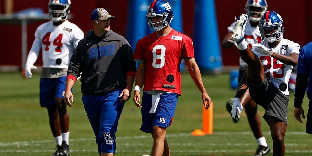 New York Giants quarterback Daniel Jones (8) talks with head coach Joe Judge during NFL football practice in East Rutherford, New Jersey, Thursday, May 27, 2021. (AP Photo/Adam Hunger)