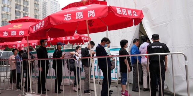 Residents line up outside a vaccination center in Beijing on Wednesday, June 2, 2021. After a slow start, China is now doing what virtually no other country in the world can: harnessing the power and all-encompassing reach of its one-party system and a maturing domestic vaccine industry to administer shots at a staggering pace. (AP Photo/Ng Han Guan)