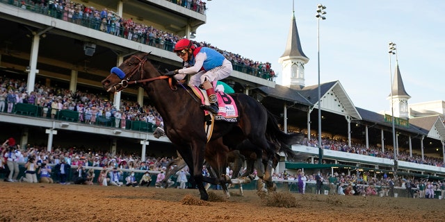 John Velazquez riding Medina Spirit crosses the finish line to win the 147th running of the Kentucky Derby at Churchill Downs in Louisville, Kentucky, May 1, 2021.
