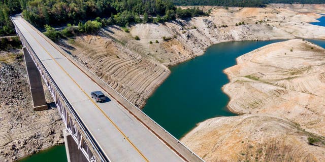 A car crosses Enterprise Bridge over Lake Oroville's dry banks Sunday, May 23, 2021, in Oroville, California. At the time of this photo, the reservoir was at 39 percent of capacity and 46 percent of its historical average. (Associated Press)