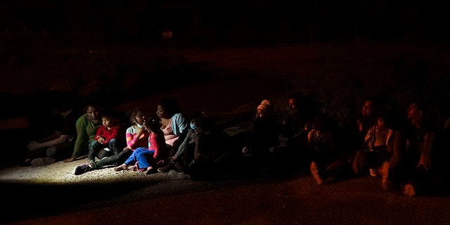 Migrants mainly from Honduras and Nicaragua sit in line after turning themselves in upon crossing the U.S.-Mexico border Monday, May 17, 2021, in La Joya, Texas. (Associated Press)