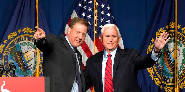Former Vice President Mike Pence, right, waves as N.H. Gov. Chris Sununu introduces him at the annual Hillsborough County NH GOP Lincoln-Reagan Dinner, Thursday, June 3, 2021, in Manchester, N.H. 