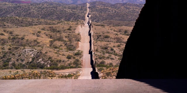 A border wall stretches along the landscape near Sasabe, Ariz. (AP Photo/Ross D. Franklin) 