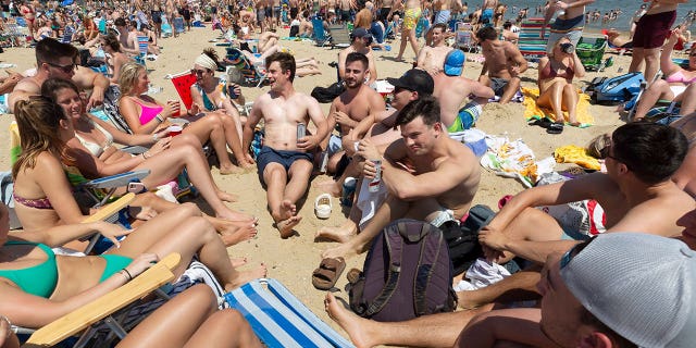 Crowds gather on L Street Beach, Saturday, June 5, 2021, in the South Boston neighborhood of Boston.