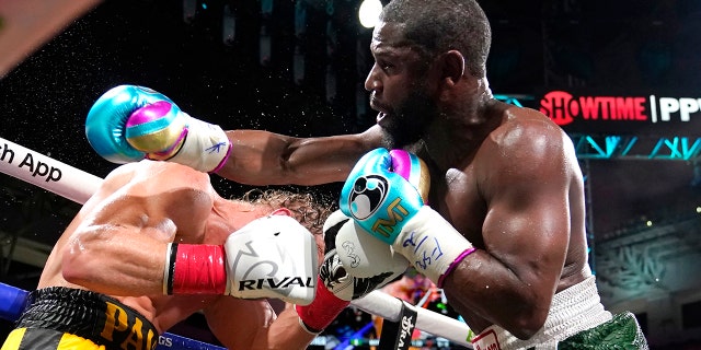 Floyd Mayweather, right, and Logan Paul fight during an exhibition boxing match at Hard Rock Stadium, Sunday, June 6, 2021, in Miami Gardens, Fla.