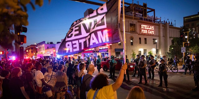 Community members face off against police, late Sunday, June 6, 2021, in Minneapolis, as they demand justice for Winston Boogie Smith Jr., who was fatally shot by members of a U.S. Marshals task force several days earlier. (AP Photo/Christian Monterrosa)