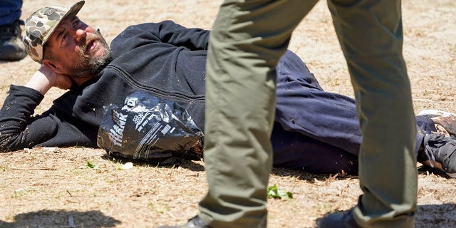 A member of the Los Angeles County Sheriffs Department's HOST, Homeless Outreach Service Team, talks to homeless man on June 8, 2019, in the Venice Beach section of Los Angeles.