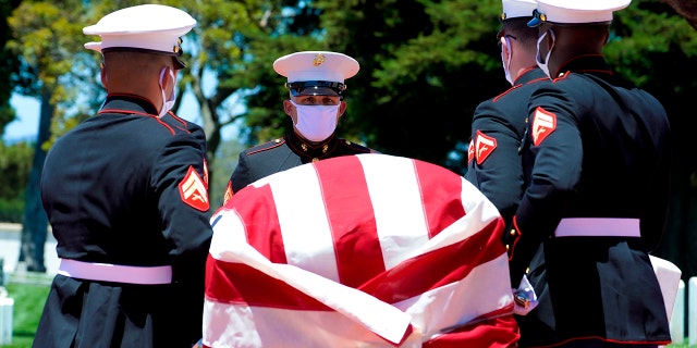 A military honor guard carries the casket of Marine Corps, Pfc. John Franklin Middleswart for a full military honors at Fort Rosecrans National Cemetery on Tuesday, June 8, 2021, in San Diego. Eighty years after he died in the attack on Pearl Harbor and just months after his remains were finally identified, the California Marine has been laid to rest with full military honors. (Nelvin C. Cepeda/The San Diego Union-Tribune via AP)