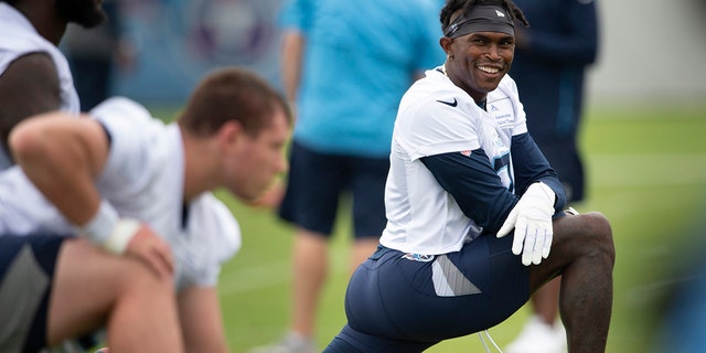 Tennessee Titans wide receiver Julio Jones, right, stretches during practice on June 10, 2021, in Nashville, Tenn.
