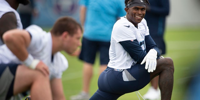 Tennessee Titans wide receiver Julio Jones, right, stretches during practice on June 10, 2021, in Nashville, Tenn.