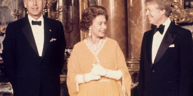 Sur cette photo d'archive datée de mai 1977, le président américain Jimmy Carter, à droite, et la reine Elizabeth II se tiennent aux côtés du président français Valery Giscard d'Estaing au palais de Buckingham à Londres. (Photo AP, fichier)