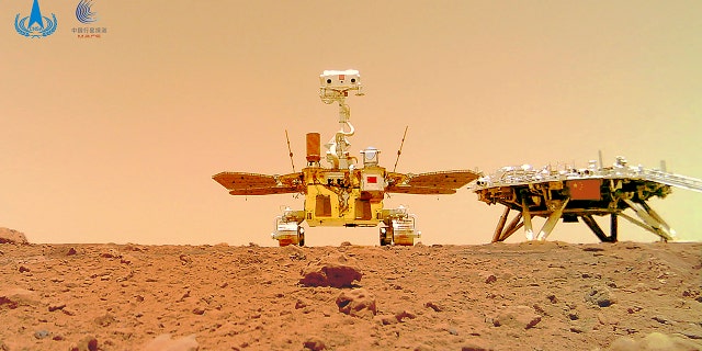 In this image released by the China National Space Administration (CNSA) on Friday, June 11, 2021, the Chinese Mars rover Zhurong is seen near its landing platform taken by a remote camera that was dropped into position by the rover. China on Friday released a series of photos taken by its Zhurong rover on the surface of Mars, including one of the rover itself taken by a remote camera. (CNSA via AP)