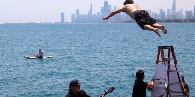 Dan O'Conor, the "Great Lake Jumper," makes his 365th leap into Lake Michigan, Saturday, June 12, 2021, in Chicago's Montrose Point.