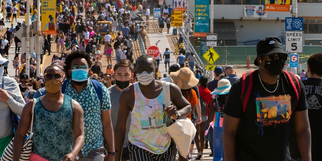 FILE - In this Saturday, May 29, 2021, file photo, people crowd the Santa Monica Pier in Santa Monica, Calif. California, the first state in America to put in place a coronavirus lockdown, is now turning a page on the pandemic. Most of California's coronavirus restrictions will disappear Tuesday, June 15, 2021. (AP Photo/Damian Dovarganes, File)