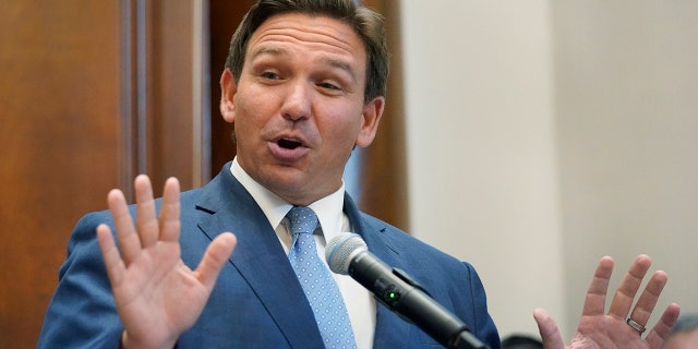 Florida Gov. Ron DeSantis gestures as he speaks, Monday, June 14, 2021, at the Shul of Bal Harbour, a Jewish community center in Surfside, Fla. DeSantis visited the South Florida temple to denounce anti-Semitism and stand with Israel, while signing a bill into law that would require public schools in his state to set aside moments of silence for children to meditate or pray. (AP Photo/Wilfredo Lee)