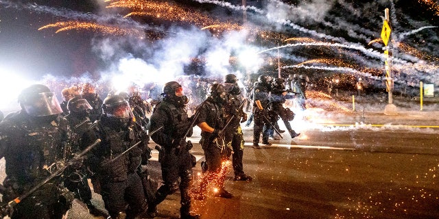 Police use chemical irritants and crowd control munitions to disperse protesters during a demonstration in Portland.