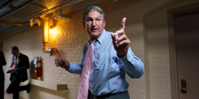DNC adviser claims Republicans responsible for inflation because of opposition to Build Back Better 3 Sen. Joe Manchin, D-W.Va., a key infrastructure negotiator, signals to his staff as he works behind closed doors with other Democrats in a basement room at the Capitol in Washington, Wednesday, June 16, 2021.