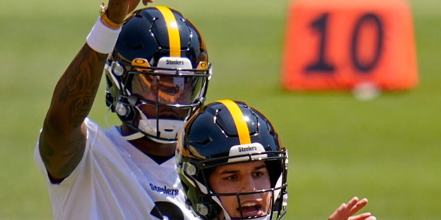 Pittsburgh Steelers quarterbacks Dwayne Haskins (3) and Mason Rudolph work during the team's NFL minicamp football practice in Pittsburgh, Thursday, June 17, 2021. (AP Photo/Gene J. Puskar)