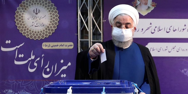 In this photo released by the official website of the office of the Iranian Presidency, President Hassan Rouhani casts his ballot for the presidential elections at the Interior Ministry in Tehran, Iran, June 18, 2021. Iran began voting Friday in a presidential election tipped in the favor of a hard-line protege of Supreme Leader Ayatollah Ali Khamenei, fueling public apathy sparking calls for a boycott in the Islamic Republic. (Iranian Presidency Office via AP)