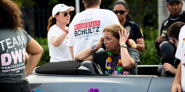 Rep. Debbie Wasserman Schultz, D-Fla., makes a call after a truck drove into a crowd of people during The Stonewall Pride Parade and Street Festival in Wilton Manors, Fla., Saturday, June 19, 2021. (Chris Day/South Florida Sun-Sentinel via AP)