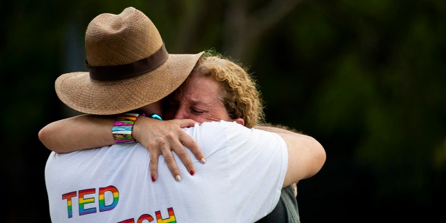 Rep. Debbie Wasserman Schultz, D-Fla., is comforted after a truck drove into a crowd of people during The Stonewall Pride Parade and Street Festival in Wilton Manors, Fla., Saturday, June 19, 2021. Wilton Manors police tweeted Saturday night that the parade was canceled due to a "tragic event." (Chris Day/South Florida Sun-Sentinel via AP)