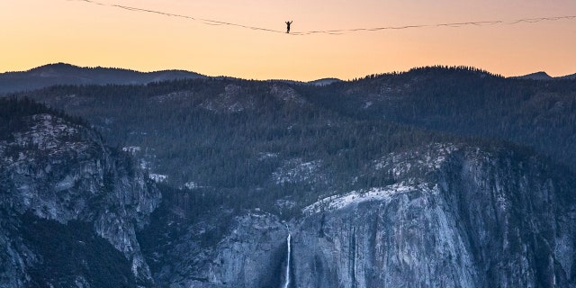 Highliner Daniel Monterrubio walks the 2,800-foot-long line off Taft Point above Yosemite Valley in Yosemite, Calif on June 12, 2021. (Scott Oller/Scott Oller Films via AP)