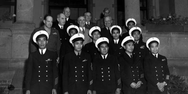 In this Aug. 1, 1945 photo, provided by the President Truman Library, President Harry S. Truman, in the third row, second from right, stands with members of his party unidentified Filipino stewards during the Potsdam conference in Germany. Asian Americans, veterans civilians in the U.S. the Philippines are campaigning to name a Navy warship for a Filipino sailor who bravely rescued two crew members when their ship caught fire more than century ago, earning him a prestigious rare Medal of Honor. (President Truman Library via AP)