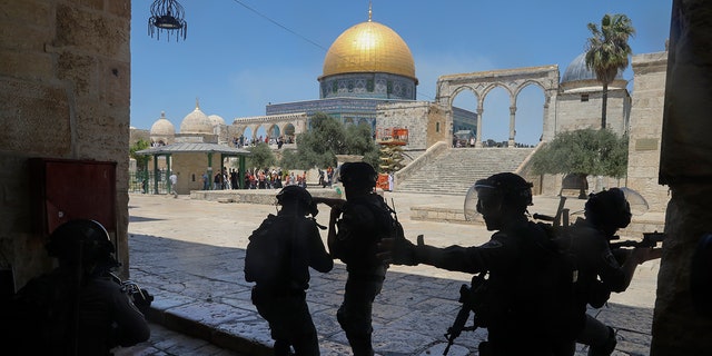 Israeli security forces take positions during clashes with Palestinians in front of the Dome of the Rock Mosque at the Al Aqsa Mosque compound in Jerusalem's Old City on June 18, 2021. (AP Photo/Mahmoud Illean, File)