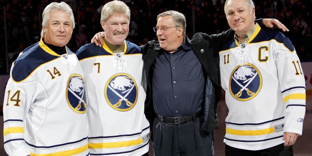 Buffalo Sabres owner Terry Pegula, second from right, poses with former "French Connection" linemates Rene Robert (14), Rick Martin (7), and Gilbert Perreault (11) before an NHL hockey game against the Atlanta Thrashers in Buffalo, N.Y on Feb. 23, 2011. (Associated Press)