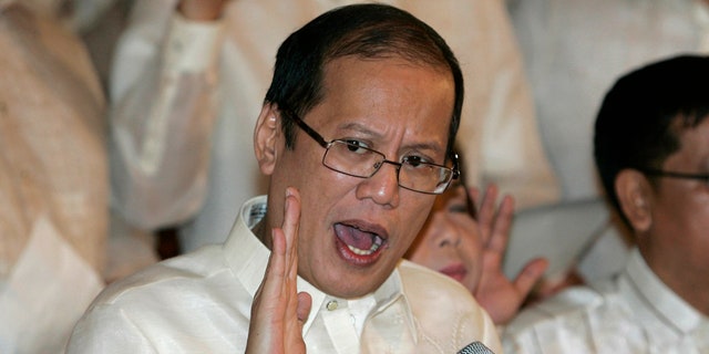 Philippine President Benigno Aquino III, center, swears in local officials during his first day at the Malacanang presidential palace in Manila, Philippines on June 30, 2010.  (AP Photo/Aaron Favila, File)