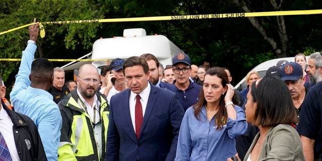 Florida Gov.  Ron DeSantis, center left, and Lt.  Gov.  Jeanette Nunez, center right, arrive for a news conference near the scene where a wing of a 12-story beachfront condo building collapsed, Thursday, June 24, 2021, in the Surfside area of ​​Miami.  (AP Photo / Lynne Sladky)