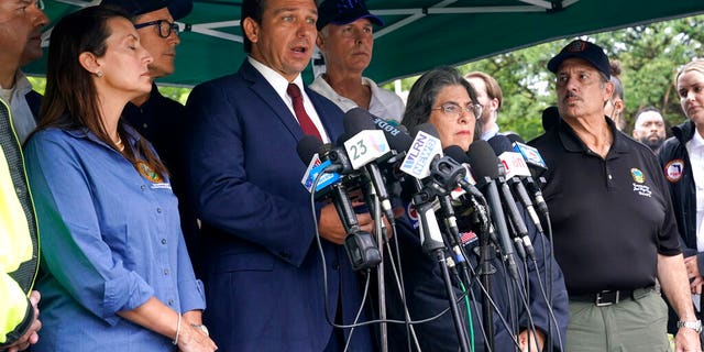 Florida Gov. Ron DeSantis, second from left, speaks during a news conference near the scene where a wing of a 12-story beachfront condo building collapsed, Thursday, June 24, 2021, in the Surfside area of Miami. At left is Lt. Gov. Jeanette Nunez, (AP Photo/Lynne Sladky)