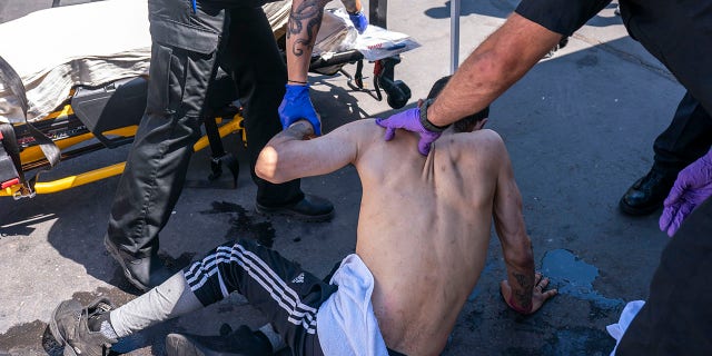 Salem Fire Department paramedics respond to a heat exposure call at a cooling center during a heat wave, Saturday, June 26, 2021, in Salem, Ore. (AP Photo/Nathan Howard)