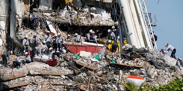 Workers search the rubble at the Champlain Towers South Condo, Monday, June 28, 2021, in Surfside, Fla. Many people were still unaccounted for after Thursday's fatal collapse. (AP Photo/Lynne Sladky)