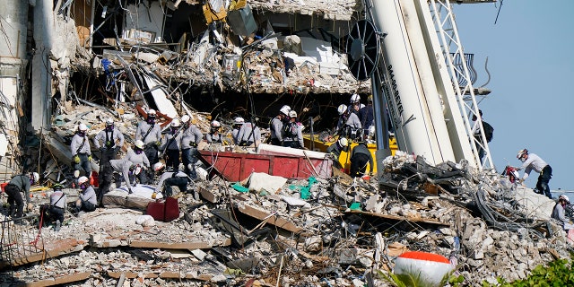 Workers search the rubble at the Champlain Towers South Condo, Monday, June 28, 2021, in Surfside, Fla. Many people were still unaccounted for after Thursday's fatal collapse. (AP Photo/Lynne Sladky)