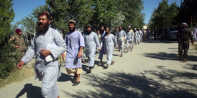 FILE - In this May 26, 2020 file photo, prisoners are released from Bagram Prison inside Bagram Air Base, in Afghanistan. In 2001 the armies of the world united behind America Bagram Air Base, barely an hours drive from the Afghan capital Kabul, was chosen as the epicenter of Operation Enduring Freedom, as the assault on the Taliban rulers was dubbed. It’s now nearly 20 years later the last US soldier is soon to depart the base. (AP Photo/Rahmat Gul, File)