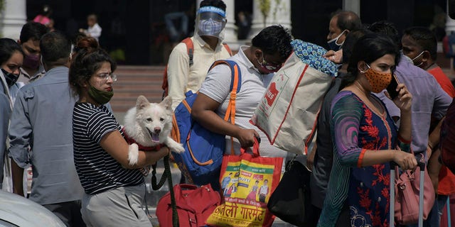 June 7, 2021: Passengers walk outside the New Delhi railway station in New Delhi. 