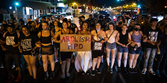 Dozens of community members march, Sunday, June 6, 2021, in Minneapolis, for Winston Boogie Smith Jr., who was fatally shot by members of a U.S. Marshals task force several days earlier.