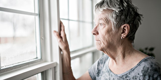 sad and lonely woman at window