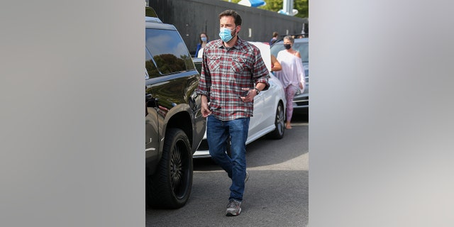 Affleck was previously photographed wearing the red and grey flannel.  (Photo by Bellocqimages/Bauer-Griffin/GC Images)