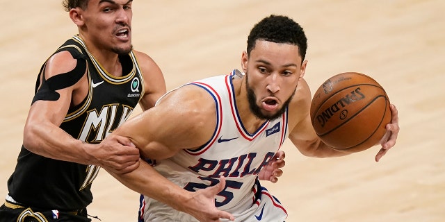 Atlanta Hawks' Trae Young (11) fouls Philadelphia 76ers' Ben Simmons (25) during the first half of Game 4 of a second-round NBA basketball playoff series on Monday, June 14, 2021, in Atlanta.
