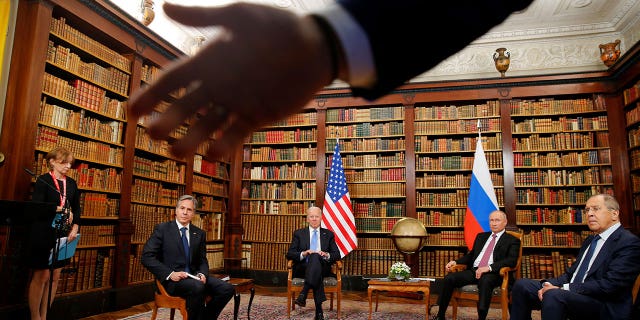 A security officer indicates to the media to step back as (From L) US Secretary of State Antony Blinken, US President Joe Biden, Russia's President Vladimir Putin and Russia's Foreign Minister Sergei Lavrov meet at the 'Villa la Grange' in Geneva on June 16, 2021. (Photo by DENIS BALIBOUSE/POOL/AFP via Getty Images)
