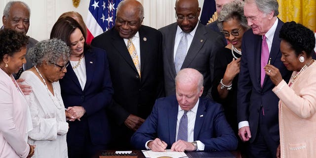 photo of President Biden signing a bill into law