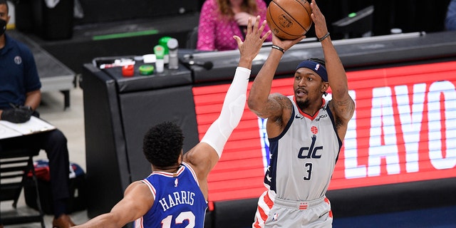 Washington Wizards guard Bradley Beal (3) shoots against Philadelphia 76ers forward Tobias Harris (12) during the first half of Game 4 in a first-round NBA basketball playoff series, Monday, May 31, 2021, in Washington. (AP Photo/Nick Wass)